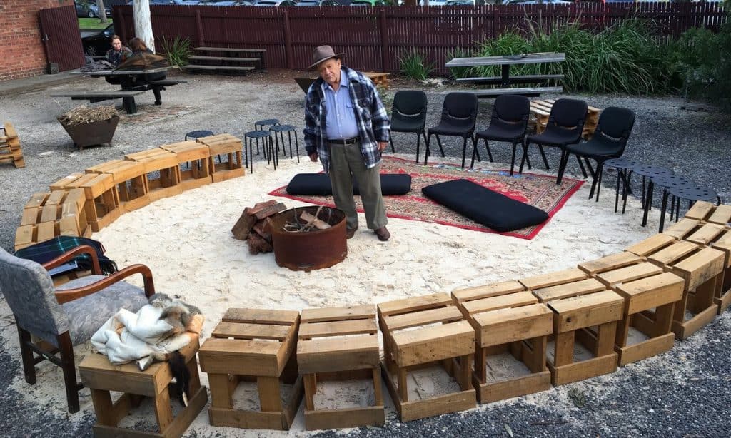 Uncle Wes standing by fire bucket