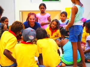 Shellie Morris surrounded by kids in a classroom. 